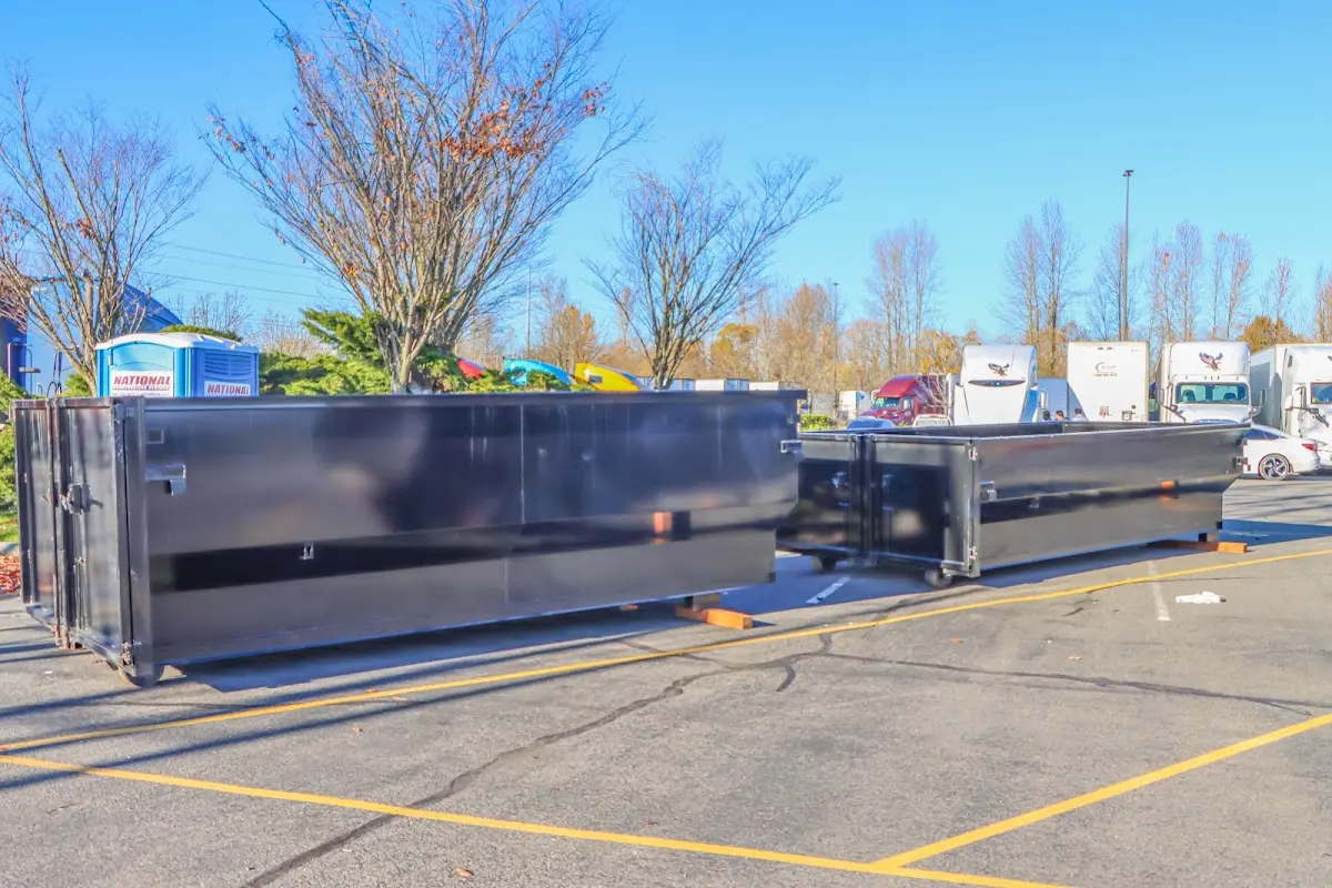 Professional dumpster rental service with roll-off container on residential driveway in Muhlenberg